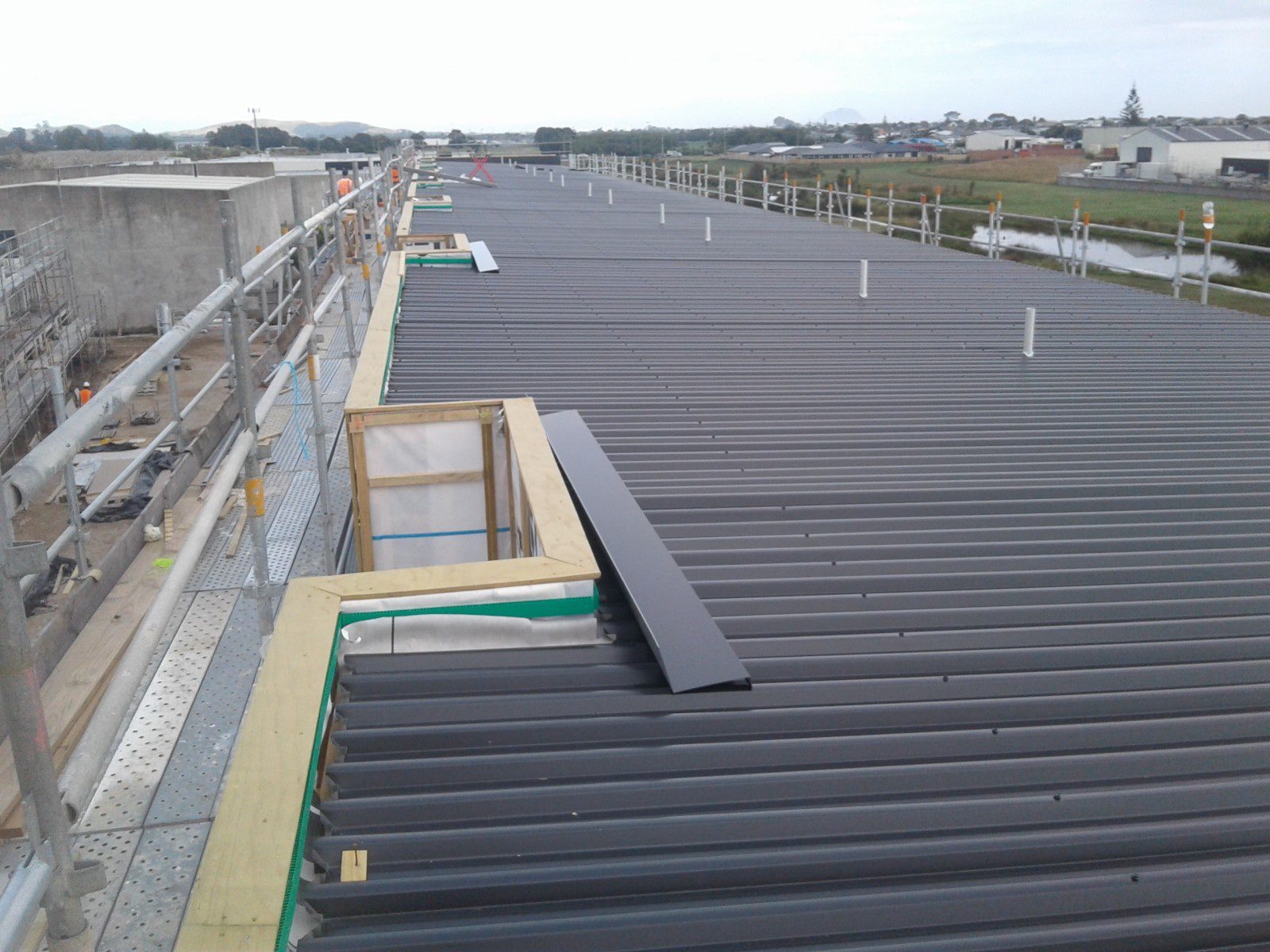 Commercial metal roofing project with roof access equipment